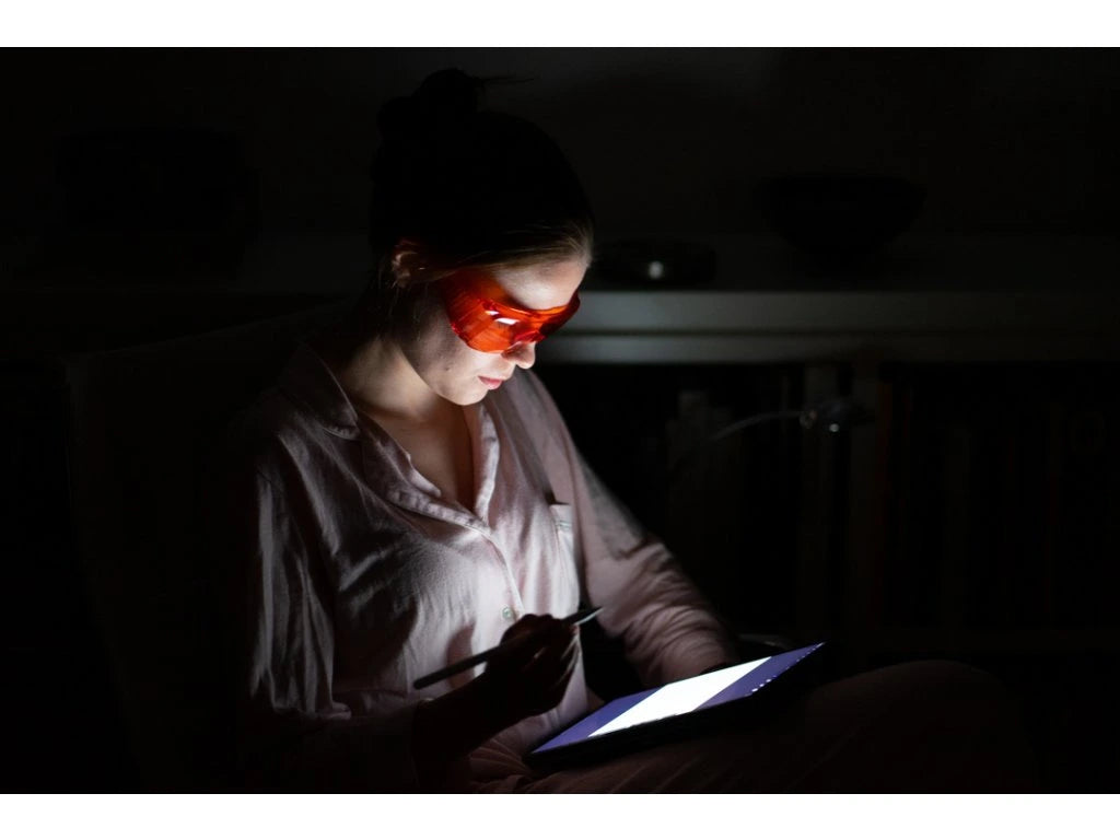 Red glasses against blue and green light.