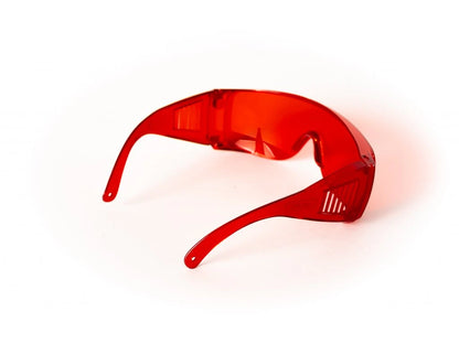 Red glasses against blue and green light.