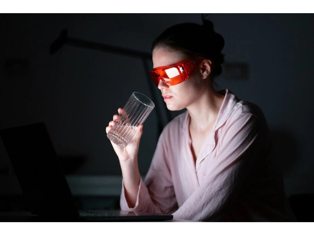 Red glasses against blue and green light.